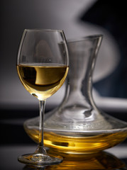 A glass full of wine and wine decanters