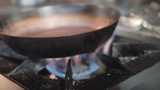 Lightining gas cooking stove, person turns on kitchen cooktop gas 