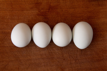 Huevos blancos en una tabla de madera
