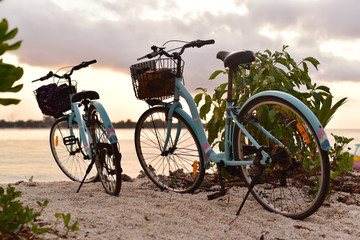 Two bicycles parked on the beach of Gili Meno Island in sunset, Lombok, Indonesia
