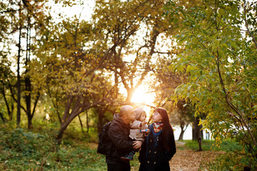 Happy family, mother, father and little son