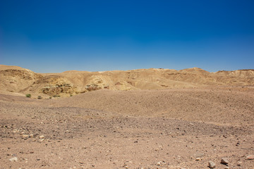 Fototapeta na wymiar desert valley wasteland scenic landscape view of nothing with sand stone bare mountain ridge background