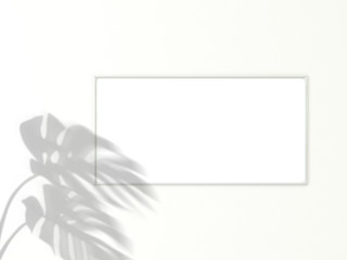 1x2 horizontal White frame for photo or picture mockup on white background with shadow of monstera leaves. 3D rendering.