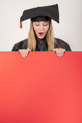 Surprised graduate holding a red placard mock-up