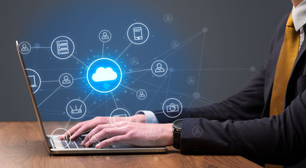 Businessman hand typing with cloud technology system and office symbol concept