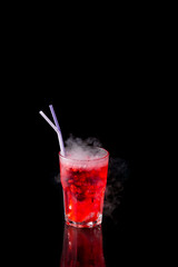red alcohol cocktail with dry ice isolated