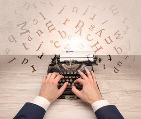 First person perspective elegant hand writing on typewriter with flying letters concept