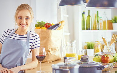 beautiful young woman using a digital tablet in the kitchen