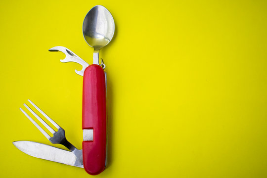 Pocket kit ( fork, spoon, knife, opener ) yellow background.