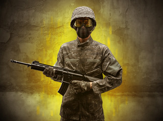 Hazard, menace soldier in a ruined crumbly building with arms on his hand