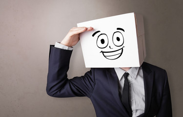 Young boy standing and gesturing with a cardboard box on his head