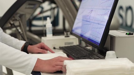 Female Medical Scientist Working with graphics on a Personal Computer in Laboratory