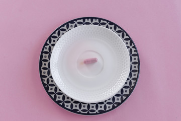 Pills in the dish. Concepts - what we eat, hidden ingredients, addictions.