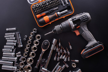 Naklejka premium Industrial locksmith tools and screwdriver on a black background