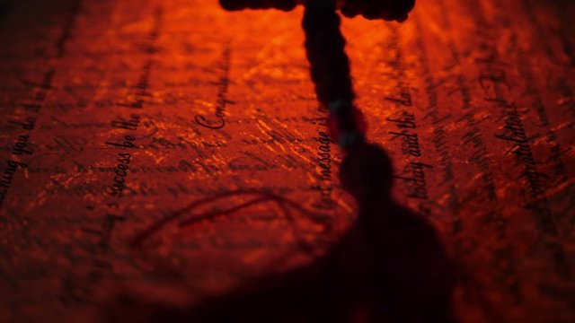 Close up of christian cross on old manuscript