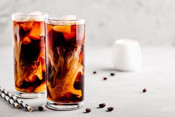 Coconut chai iced coffee with ice cubes in tall glasses