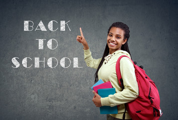 girl pointing on back to School sign