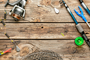 Different fishing accessories on wooden background