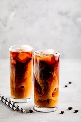 Caramel vanilla iced coffee with ice cubes in tall glasses