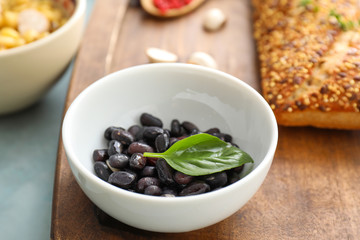 Bowl with raw beans on table