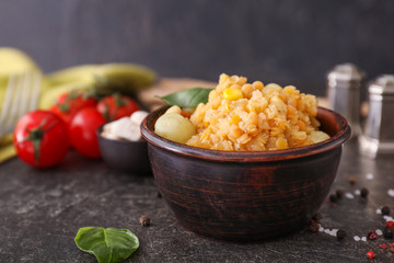 Bowl with boiled peas and potato on dark table
