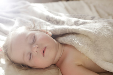 Fototapeta na wymiar Baby girl sleeping in bed. Sleeping little baby. 