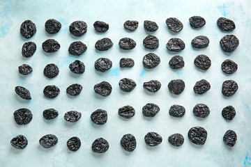 Tasty prunes on color background
