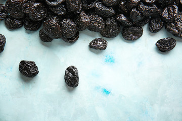 Tasty prunes on color background