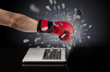 Strong male hand breaks laptop screen