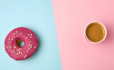 round red glazed donut and paper cup with coffee