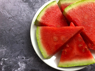 Sweet, juicy, organic watermelon slices on stone background. Food concept.