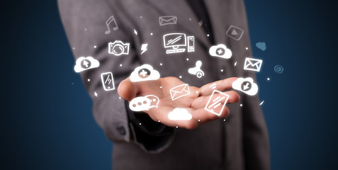 Hand holding application icons and symbols in her hand