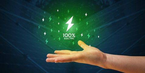 Hand in suit holding lightning bolt on his hand, green environment concept