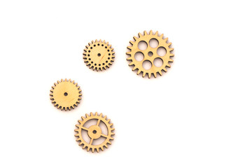separated wooden gears of different sizes isolated on white background
