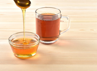 Honey in a jar on a wooden background