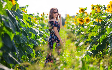 Happy woman in a field of sunflowers