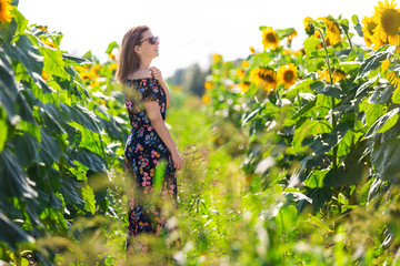 Happy woman in a field of sunflowers