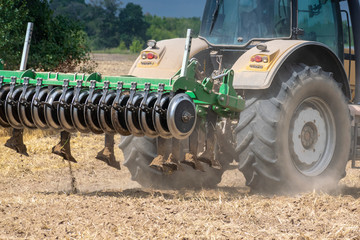 Tractor cultivating the field