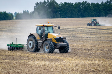 Fototapeta na wymiar Tractor cultivating the field