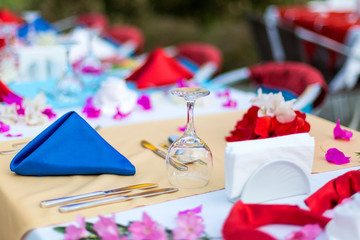 Laid tables for the holiday on the street. The outdoor restaurant festively decorated with tables and chairs.