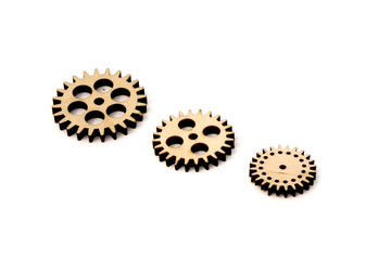 three wooden gears of different size isolated on white background