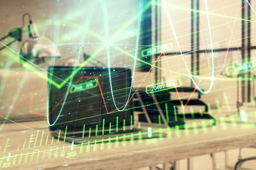 Forex graph hologram with desktop office computer background. Double exposure. Concept of financial analysis.