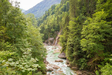 Fototapeta na wymiar Scenic view of a river with emerald or turquoise colored water in a valley in Tirol, Austria