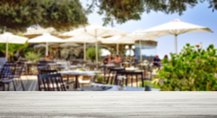 Table background with blurred restaurant view. Empty space for advertising products and decoration.