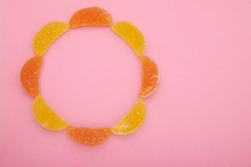 Delicious jelly candies on pink background