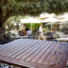 Table background with blurred restaurant view. Empty space for advertising products and decoration.