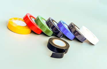 Set of multicolored insulating tapes on gray background