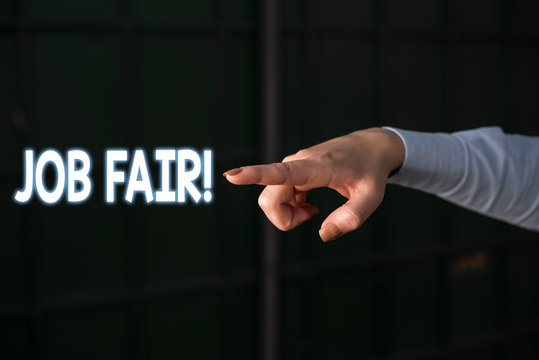 Text sign showing Job Fair. Business photo showcasing event in which employers recruiters give information to employees Finger pointing in the Dark with hand pointing in the copy space