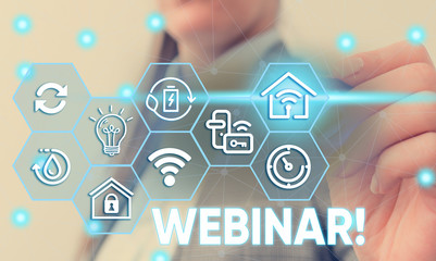 Conceptual hand writing showing Webinar. Concept meaning seminar or other presentation types that takes place on Internet Female human wear formal work suit presenting smart device