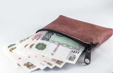 Russian ruble in a leather bag on a white background.